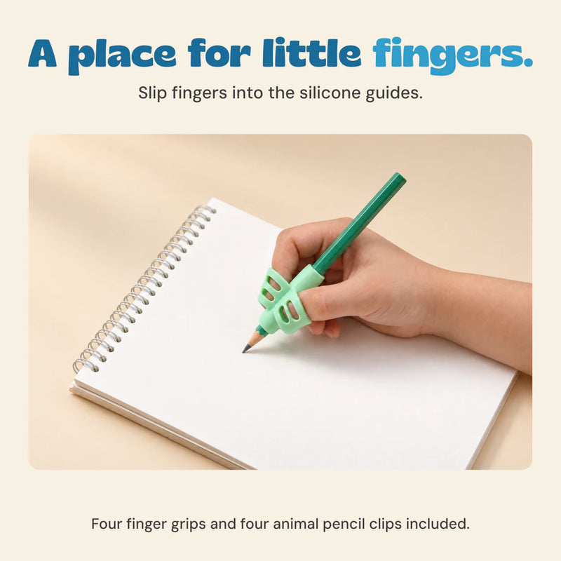 A hand uses the mint silicone finger grip on a green pencil over a notebook.
