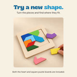 A hand moves a yellow wooden tangram piece beside the square puzzle board on a warm beige surface.