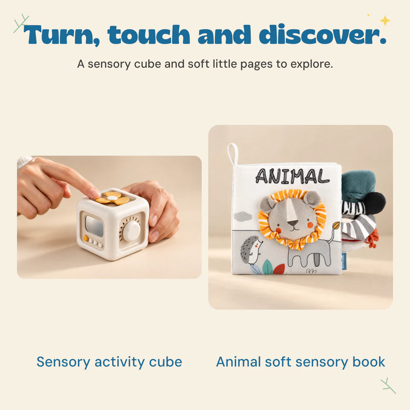 Hands explore the cube spinner beside the Animal sensory book with its lion cover and soft fabric details.
