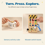 Hands explore the white sensory cube and wooden switch board, with the board lights illuminated.