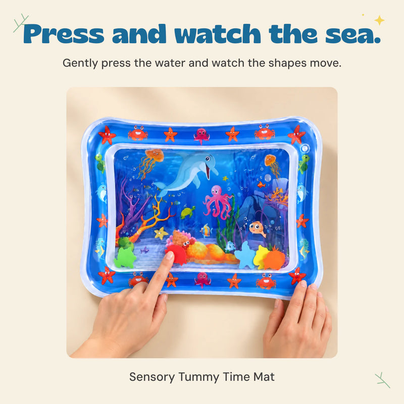 Hands gently press the blue ocean water mat to move its floating shapes.