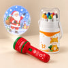 Christmas Eve Story and Colour Gift with a red Christmas projector showing a Santa picture and a twelve-piece Silky Twist-Up Crayon Set in a giraffe carrying tub.
