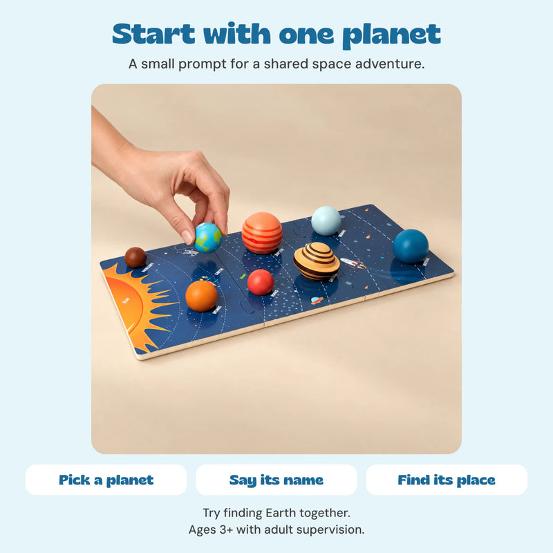 One hand places the raised Earth piece on the Solar System Planet Puzzle Board. Pick a planet, say its name and find its place.