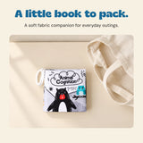 The Animal Cognition fabric book lies beside a plain cream tote on a warm beige table.