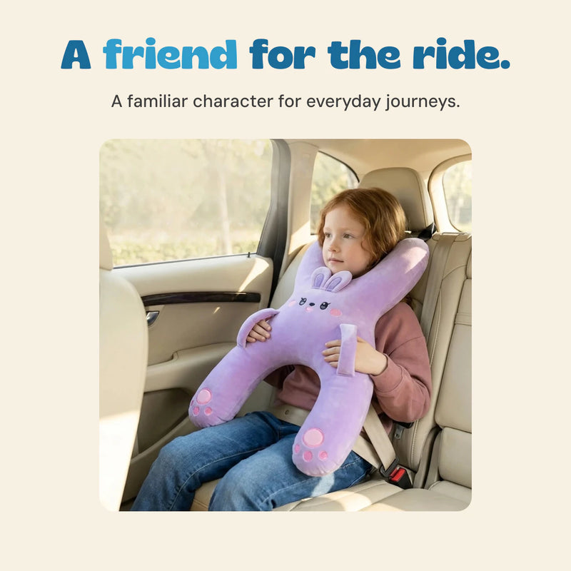 A girl holds the lavender bunny travel pillow while seated in a car.