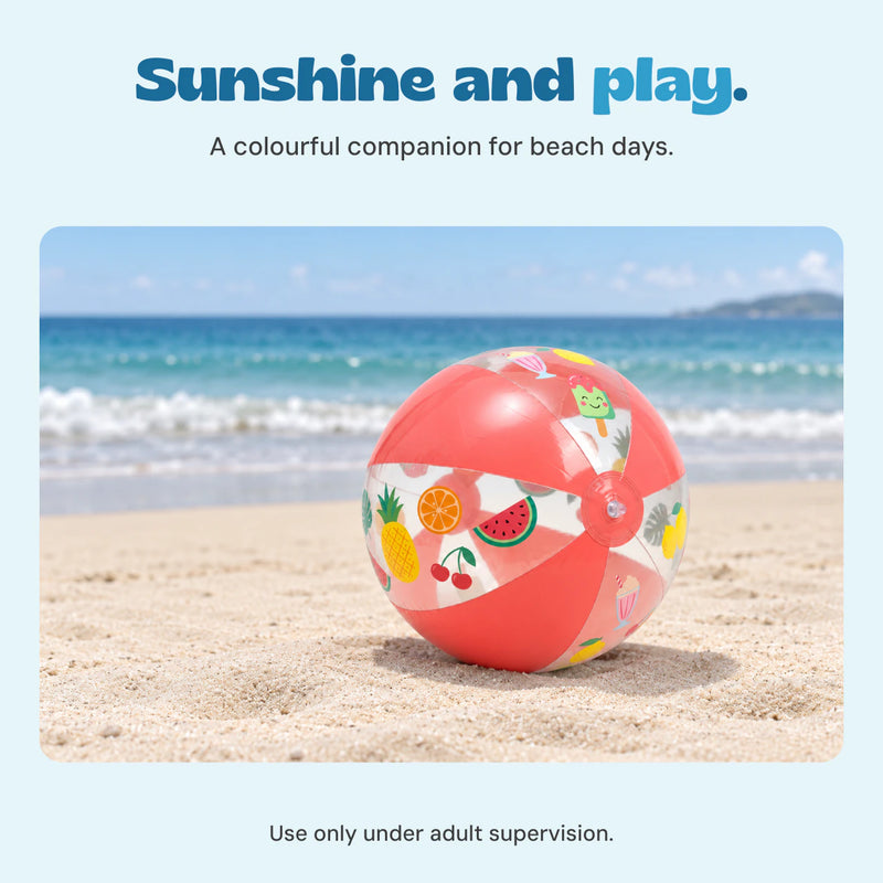 The Fruity Splash beach ball rests on pale sand beside the sea.