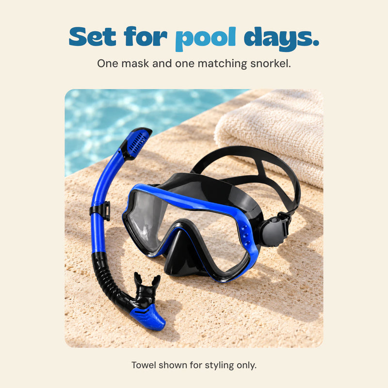 The Dolphin Blue mask and separate snorkel sit beside a pool. The towel is a styling prop.