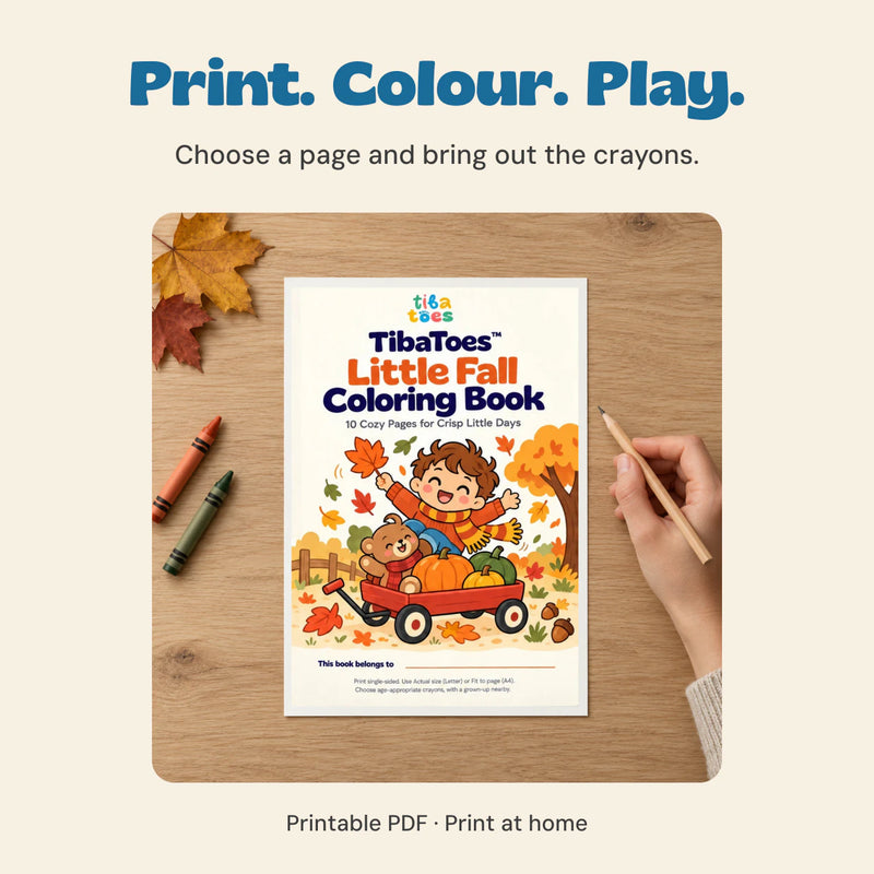 Adult hand holding a pencil beside a printed example of the original Little Fall Coloring Book cover on a quiet table.