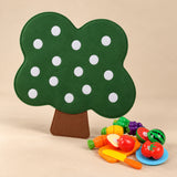 Green tree felt activity board with the supplied pretend food and play utensils.