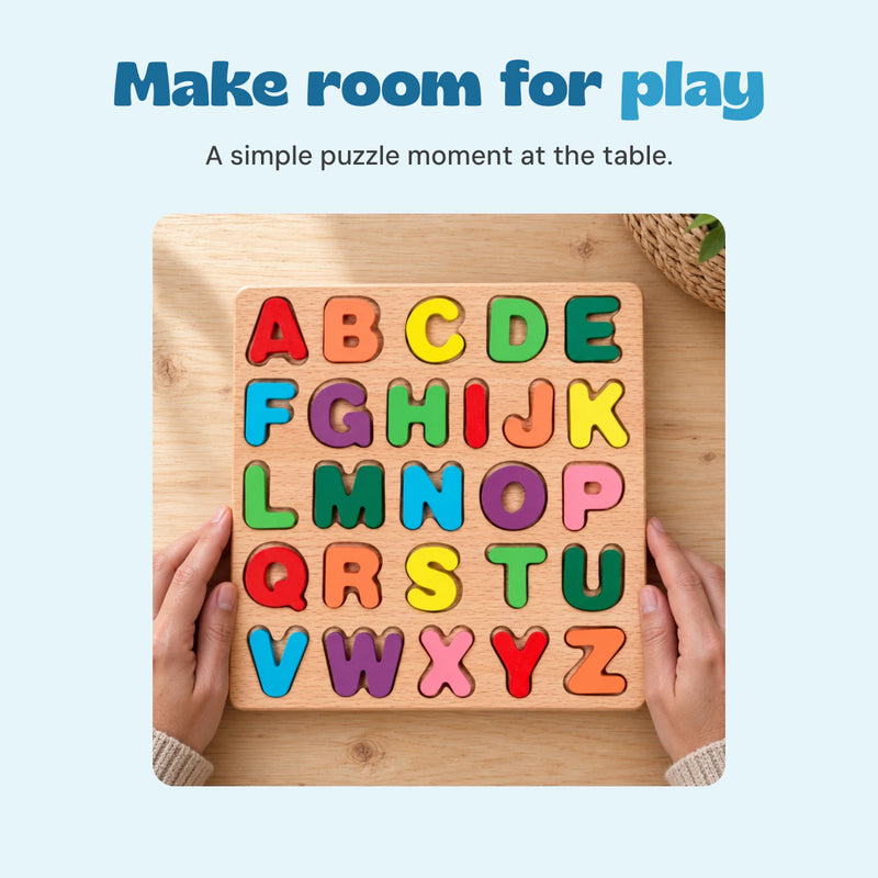 Adult hands holding the original alphabet puzzle design on a natural wood table.