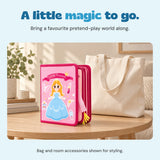 Closed Little Princess busy book on an oak table beside a cream tote bag.