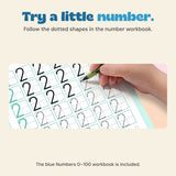 A hand traces the number two on a NumberQuest workbook page with printed practice rows.
