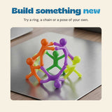 Six colourful magnetic figures connected into a standing ring on a metal surface.