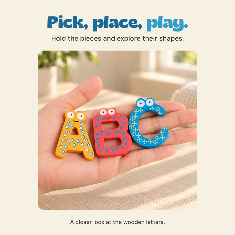 An open hand holds the colourful wooden letters A, B and C in warm window light.