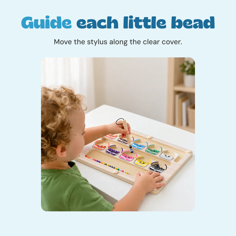 The existing source child using the wooden stylus to guide a bead on the monster sorting board.