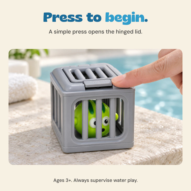 An adult fingertip presses the gray rescue cage lid tab, with one green puffer toy visible inside. Ages 3+. Adult supervision required for water play.