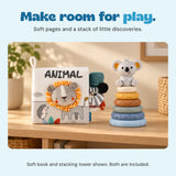 The ANIMAL lion cloth book and six-ring koala stacking tower stand together on a calm wooden shelf.
