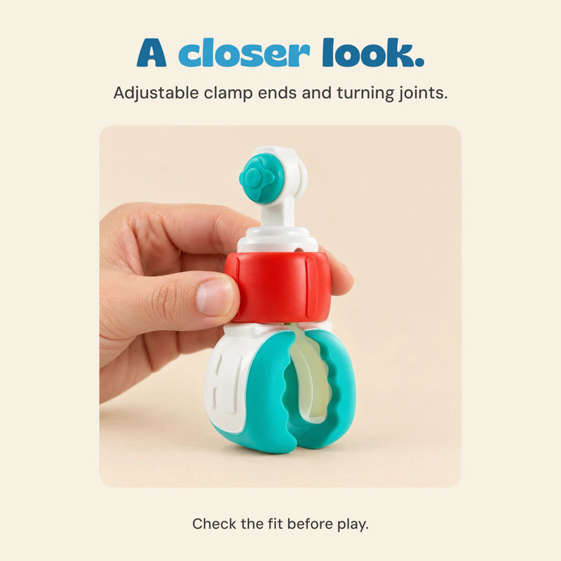 Adult hand holding the red adjustment collar above the turquoise clamp end of the play arch.