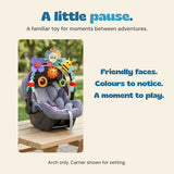 Original photograph of the colourful play arch attached to a stationary baby carrier on a wooden bench. Carrier is not included.