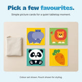 Four unchanged colour-set cards on a calm tabletop beside a plain pouch.