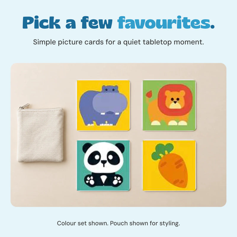 Four unchanged colour-set cards on a calm tabletop beside a plain pouch.