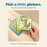A hand holds a fan of picture cards with a green dinosaur pattern at the front.