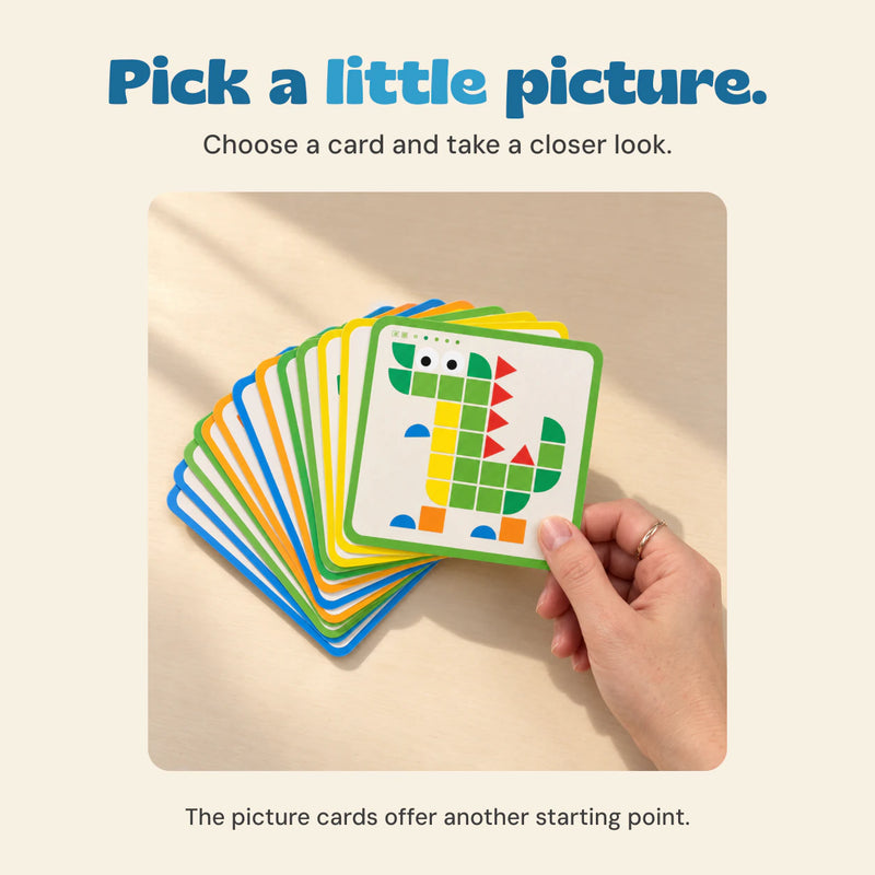A hand holds a fan of picture cards with a green dinosaur pattern at the front.