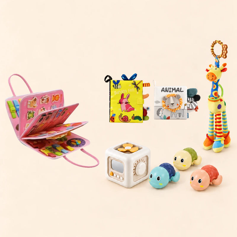 Mermaid Pink Plus busy board with a busy cube, Garden Fun cloth book, Animal lion soft book, giraffe rattle and three turtle bath toys on a pale beige background.
