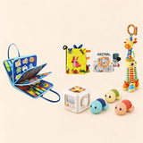 Vehicle Blue Plus busy board with a busy cube, Garden Fun cloth book, Animal lion soft book, giraffe rattle and three turtle bath toys on a pale beige background.
