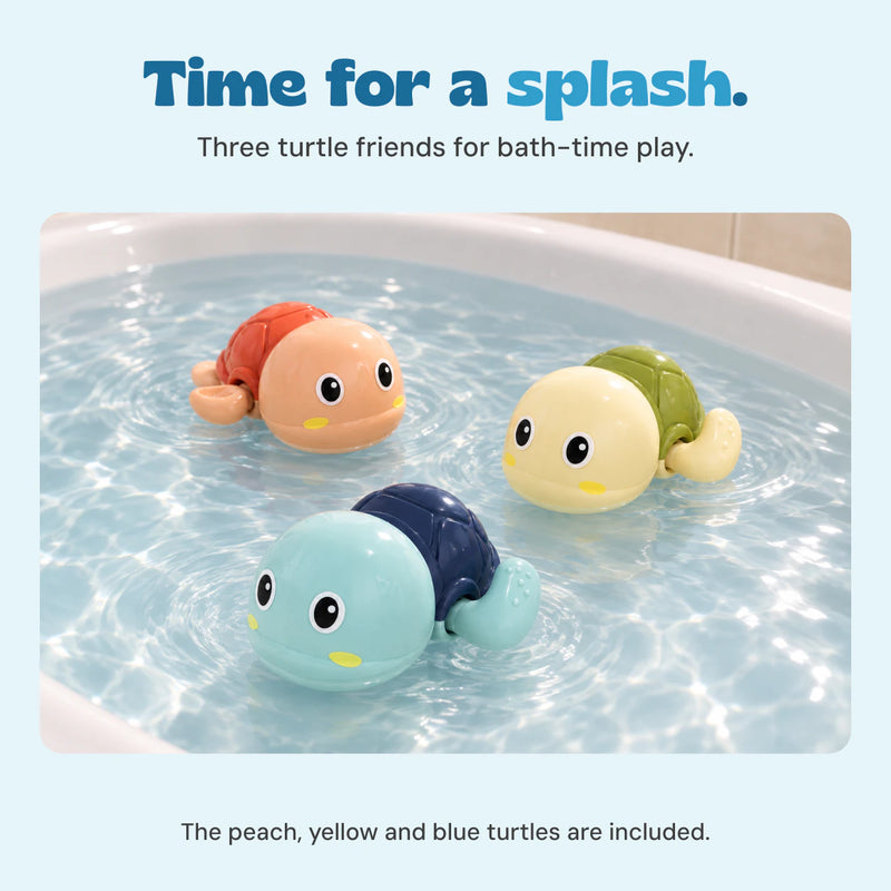 Three turtle bath toys float in a bath of clear water.