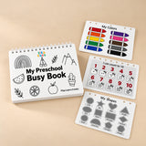 White TibaToes Preschool Busy Book with colours, counting and shapes page previews arranged on a warm beige studio surface