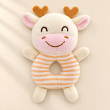 Burnt Orange rattle friend: cream cow with orange horns and orange striped ring body.