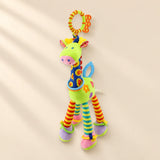Green giraffe rattle with patterned blue neck, striped legs, coloured rings and an orange and lime hanging loop.