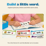A child uses word cards at a table beside the blue WordBuilder box.