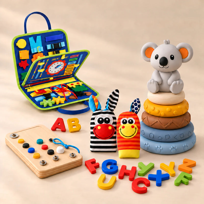 Ultimate Explorer Bundle with blue activity suitcase, five-ring koala stacker, two fabric animal toys, wooden activity board and colourful loose letters on a warm beige studio surface