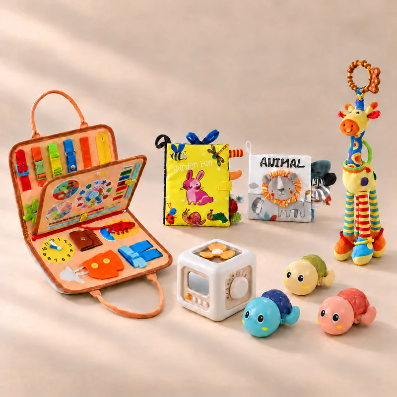 No-Screen Starter Kit Bundle with orange animal busy board, sensory books, busy cube, giraffe and turtle toys on a warm beige studio surface