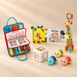 No-Screen Starter Kit Bundle with Rocket Green Plus busy board, two sensory books, busy cube, giraffe rattle and three turtle toys on a warm beige studio surface.