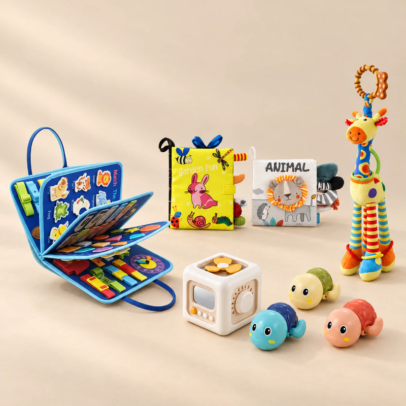 No-Screen Starter Kit Bundle with its matching busy board, cloth books, busy cube, giraffe rattle and three turtle toys on a warm beige studio surface.