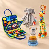Calm and Focus Bundle with a dinosaur blue busy board, grey elephant comforter, giraffe rattle and six-ring koala stacking tower on a warm beige studio floor.