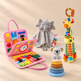 Calm and Focus Bundle with a mermaid pink busy board, grey elephant comforter, giraffe rattle and six-ring koala stacking tower on a warm beige studio floor.
