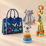 Calm and Focus Bundle with a closed blue dinosaur busy board, elephant comforter, giraffe rattle and six-ring koala stacker on a beige studio surface.