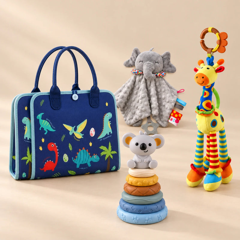 Calm and Focus Bundle with a closed blue dinosaur busy board, elephant comforter, giraffe rattle and six-ring koala stacker on a beige studio surface.