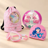 Holiday Summer Bundle, Pink colour choice, with backpack, goggles, swim cap and beach ball on a warm beige studio surface.