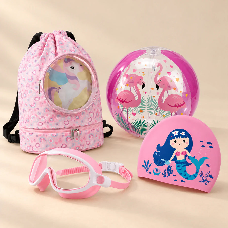 Holiday Summer Bundle, Pink colour choice, with backpack, goggles, swim cap and beach ball on a warm beige studio surface.