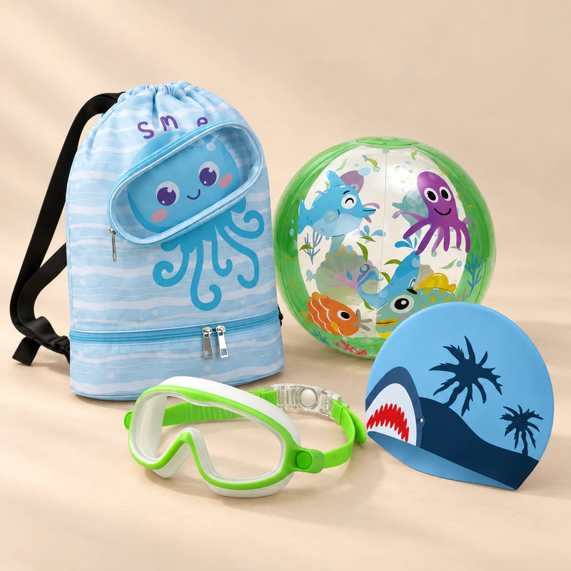 Holiday Summer Bundle, Green colour choice, with backpack, goggles, swim cap and beach ball on a warm beige studio surface.