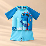 TibaToes™ FloatPal Kids Buoyancy Swimsuit photographed with its matching design and colours on a warm beige studio surface.