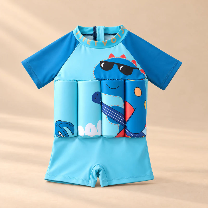 TibaToes™ FloatPal Kids Buoyancy Swimsuit photographed with its matching design and colours on a warm beige studio surface.