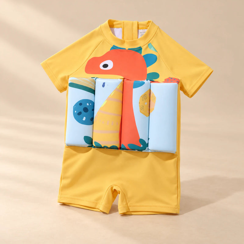 TibaToes™ FloatPal Kids Buoyancy Swimsuit photographed with its matching design and colours on a warm beige studio surface.