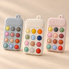 Click & Calm Silicone Phone Teether colour choices in Misty Grey, Vanilla Cream and Blush Pink on a warm beige studio background