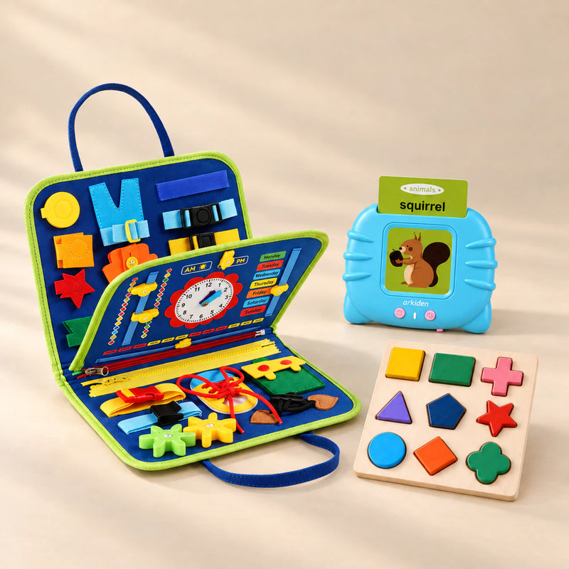 Focus Foundations Bundle with Dinosaur Blue busy board, blue talking flashcard reader and wooden shape puzzle on a warm beige studio surface.